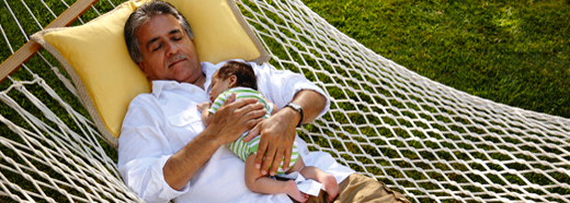 man in hammock with baby
