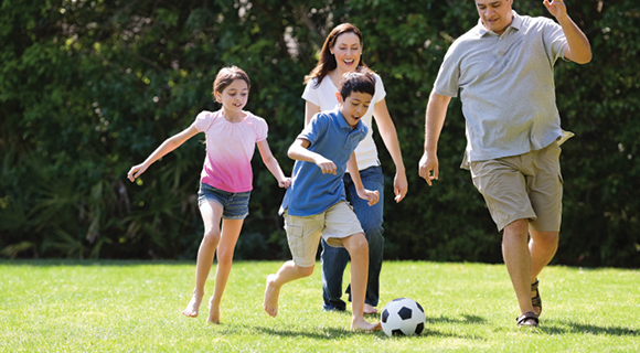 Family playing soccer