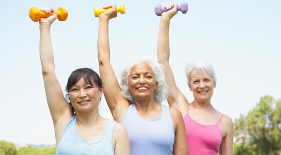 Three senior women lifting hand weights