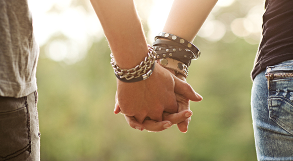 Photo of teens holding hands with many bracelets
