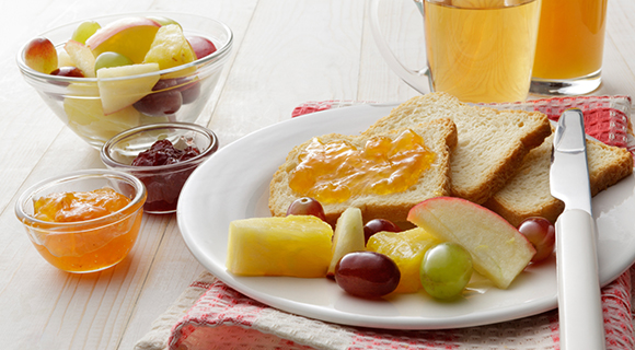 Plate of fruit and toast with jam