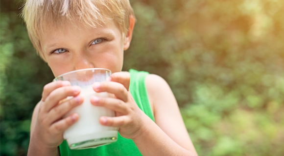 Young boy drinking glass of milk